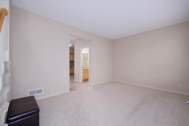 spare room featuring light colored carpet