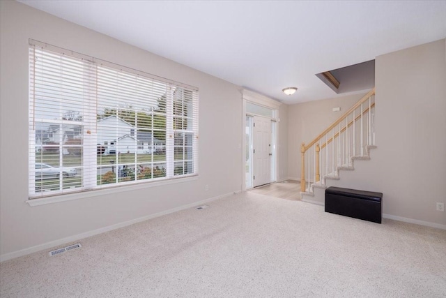 view of carpeted foyer entrance