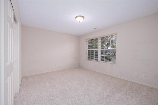 spare room with light carpet