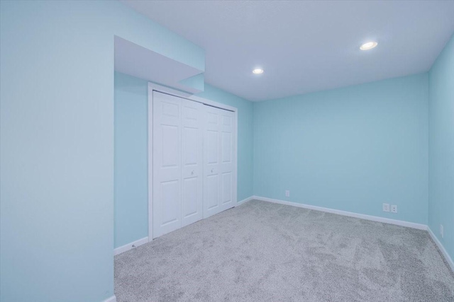 unfurnished bedroom with carpet and a closet