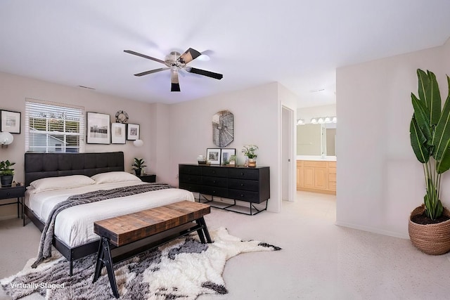 bedroom with connected bathroom, ceiling fan, and light carpet