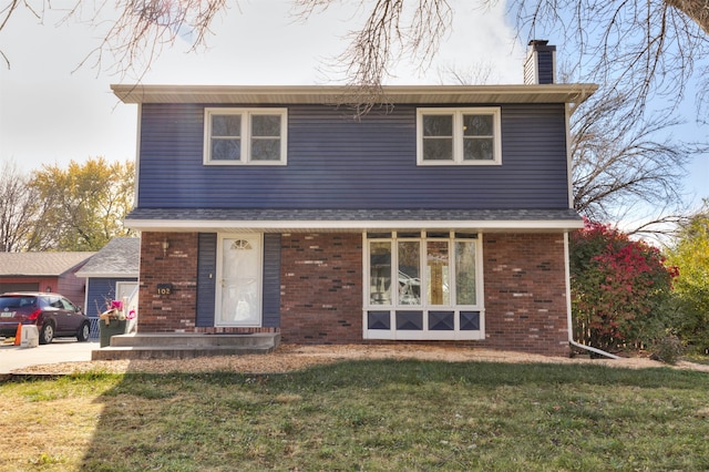 rear view of house with a lawn