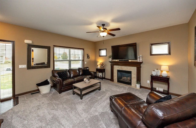 living room with ceiling fan, a fireplace, and carpet