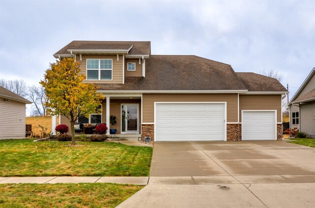 craftsman-style home with a garage and a front lawn