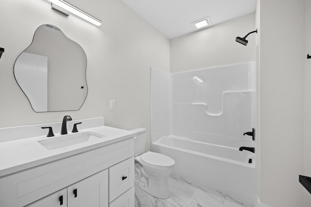 bathroom featuring toilet, marble finish floor, bathtub / shower combination, and vanity