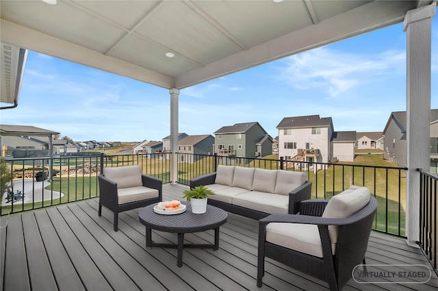 deck featuring a residential view, outdoor lounge area, and a lawn