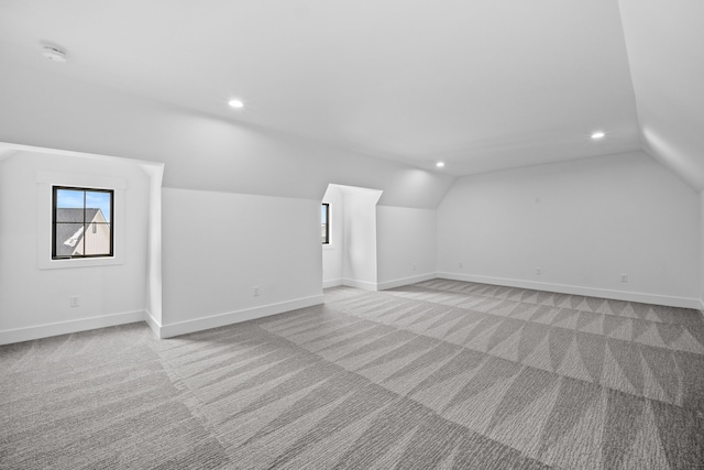 bonus room featuring light carpet and lofted ceiling