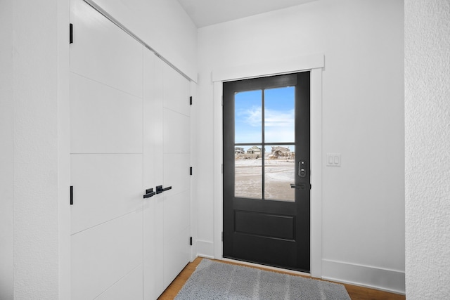 doorway with hardwood / wood-style flooring