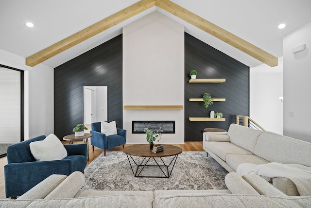 living room with beamed ceiling, wood-type flooring, and high vaulted ceiling