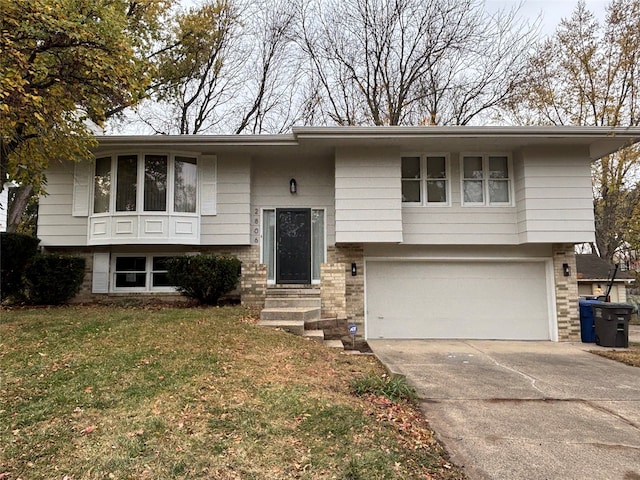 split foyer home featuring a garage and a front yard