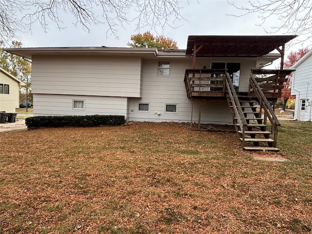 back of property with a yard and a deck