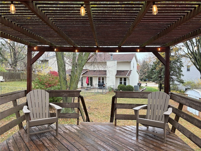 wooden terrace with a pergola and a lawn