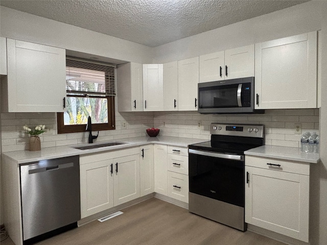 kitchen featuring white cabinetry, sink, and stainless steel appliances