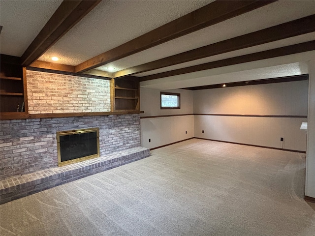 unfurnished living room featuring a fireplace, beamed ceiling, a textured ceiling, and carpet