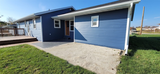 back of house with a patio, a yard, and a deck