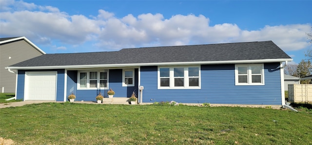 single story home with a garage and a front lawn