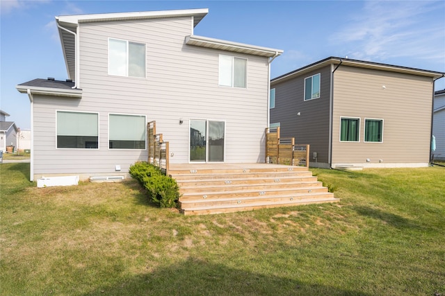 rear view of house with a deck and a lawn