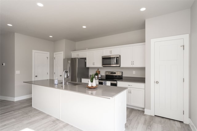 kitchen with white cabinetry, sink, an island with sink, and stainless steel appliances