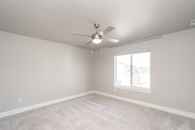 empty room with light colored carpet and ceiling fan