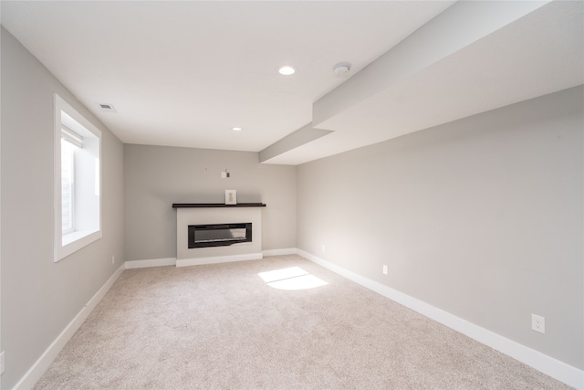 unfurnished living room featuring carpet floors