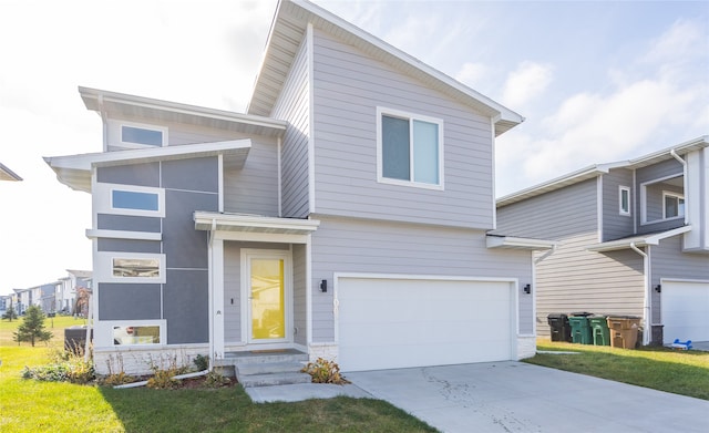 view of front of house with a front lawn and a garage