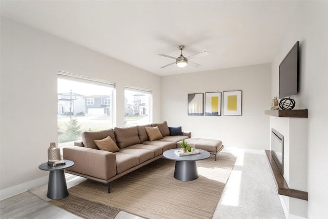 living room featuring ceiling fan and hardwood / wood-style floors