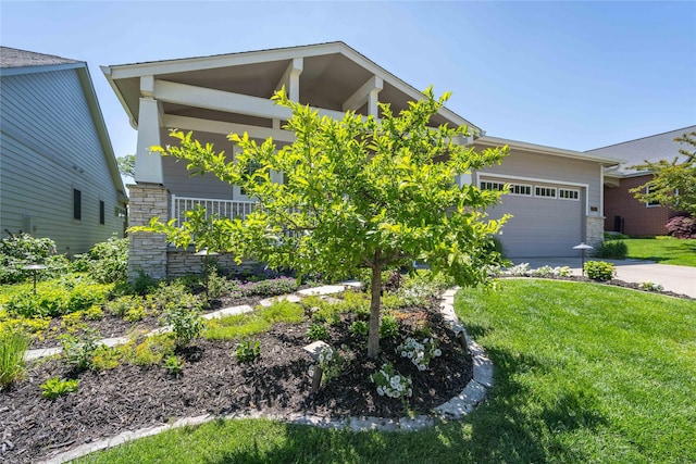 1902 Park Ave, Des Moines, IA 50315 - view of front of house featuring stone siding, driveway, an attached garage, and a front yard