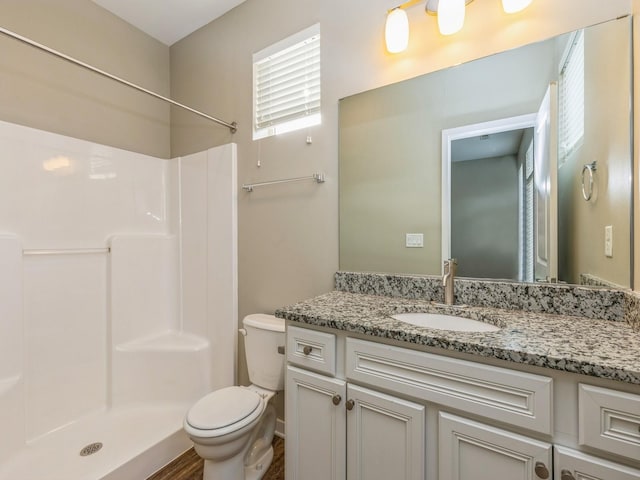 313 SW 7th St Unit 107, Des Moines, IA 50309 - full bath featuring toilet, a shower, and vanity