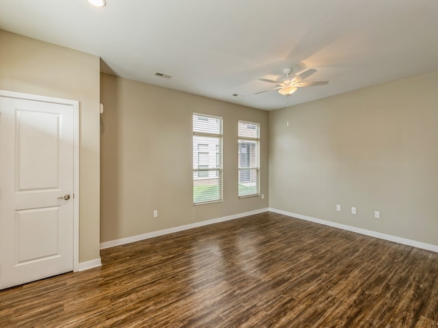 unfurnished room featuring dark hardwood / wood-style floors and ceiling fan