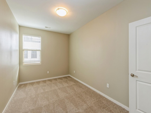 313 SW 7th St Unit 107, Des Moines, IA 50309 - unfurnished room with light carpet and baseboards