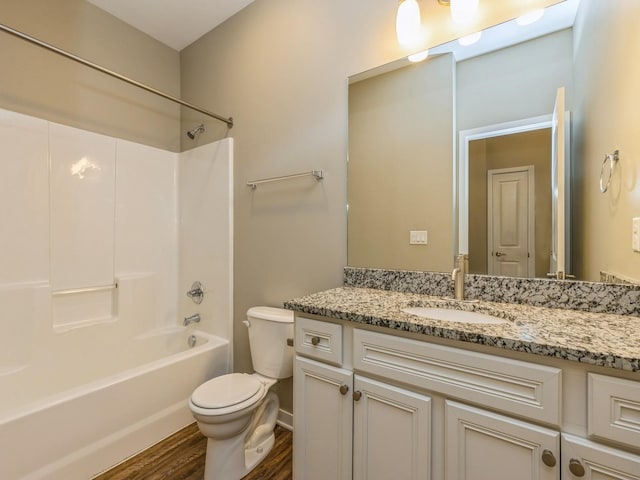 313 SW 7th St Unit 107, Des Moines, IA 50309 - full bathroom featuring toilet, wood finished floors, vanity, and bathing tub / shower combination