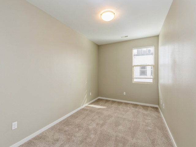 empty room with light colored carpet