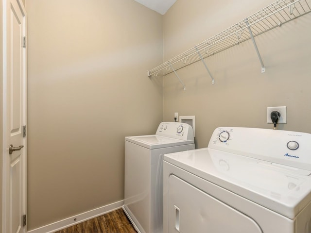 313 SW 7th St Unit 107, Des Moines, IA 50309 - clothes washing area featuring washing machine and clothes dryer, dark wood finished floors, and baseboards