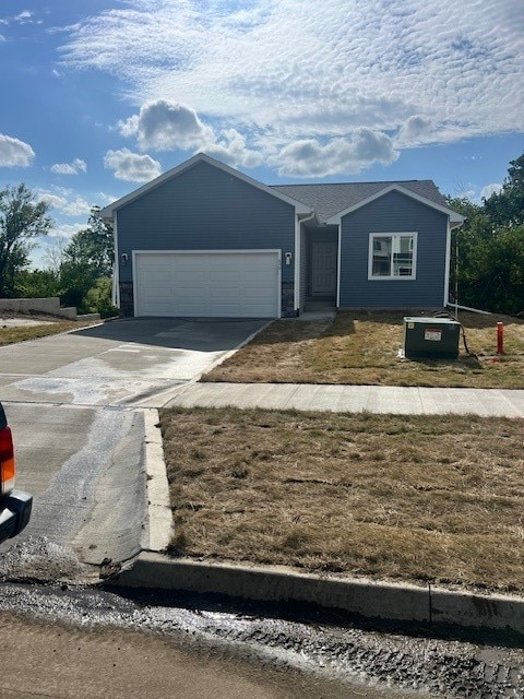 view of front of home with central air condition unit and a garage