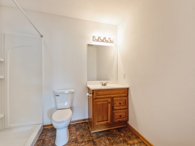 bathroom featuring vanity, a textured ceiling, toilet, and a shower