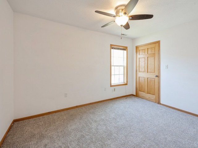 spare room with ceiling fan and carpet floors