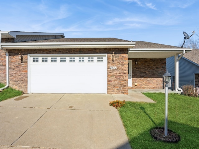 view of front of home with a garage and a front lawn