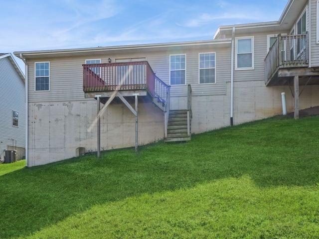 back of house with central air condition unit, a yard, and a wooden deck