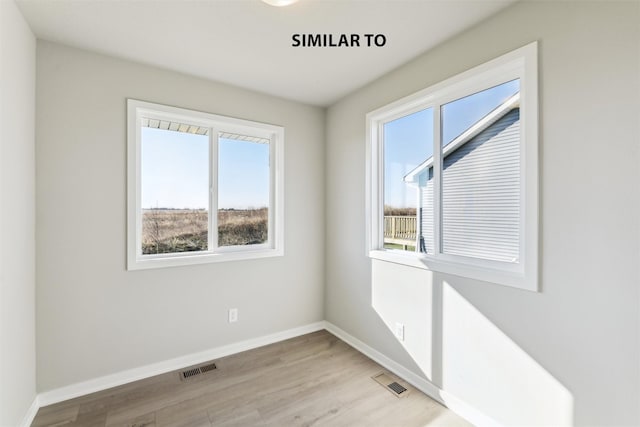 unfurnished room with light hardwood / wood-style floors