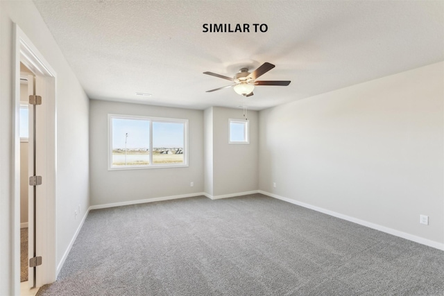 carpeted empty room with a textured ceiling and ceiling fan