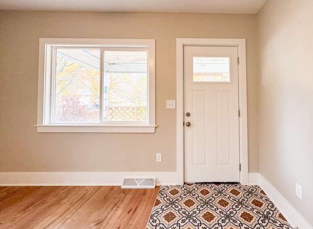 entrance foyer featuring a wealth of natural light and light hardwood / wood-style floors