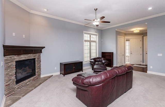 living room featuring a fireplace, ceiling fan, light carpet, and crown molding