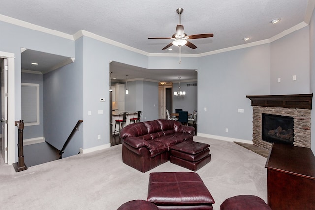 living room featuring a stone fireplace, light colored carpet, a textured ceiling, ornamental molding, and ceiling fan