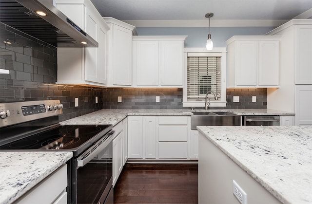 kitchen featuring white cabinetry, appliances with stainless steel finishes, pendant lighting, dark wood-type flooring, and wall chimney exhaust hood