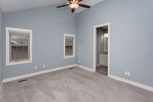 unfurnished room featuring ceiling fan, light carpet, and vaulted ceiling