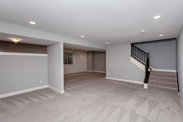 basement with a textured ceiling and carpet flooring