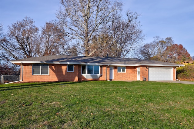 single story home with a garage and a front lawn