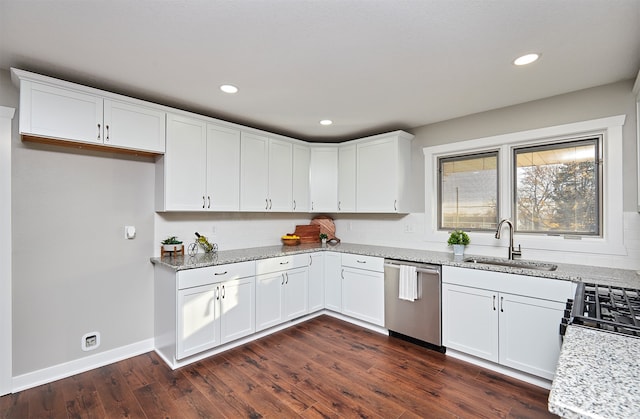 kitchen featuring white cabinets, sink, stainless steel dishwasher, dark hardwood / wood-style flooring, and light stone counters