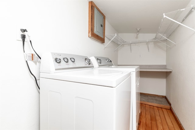 laundry area featuring light wood-type flooring and washer and clothes dryer