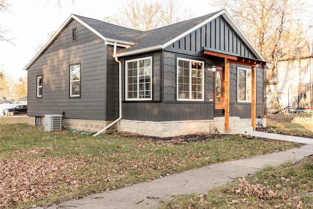 view of property exterior with central AC and a yard